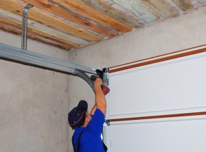 Contractor Installing Garage Door Post Rail and Spring Installa